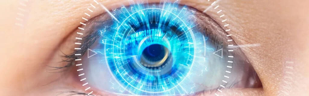 A close up of an eye with blue light coming from it.