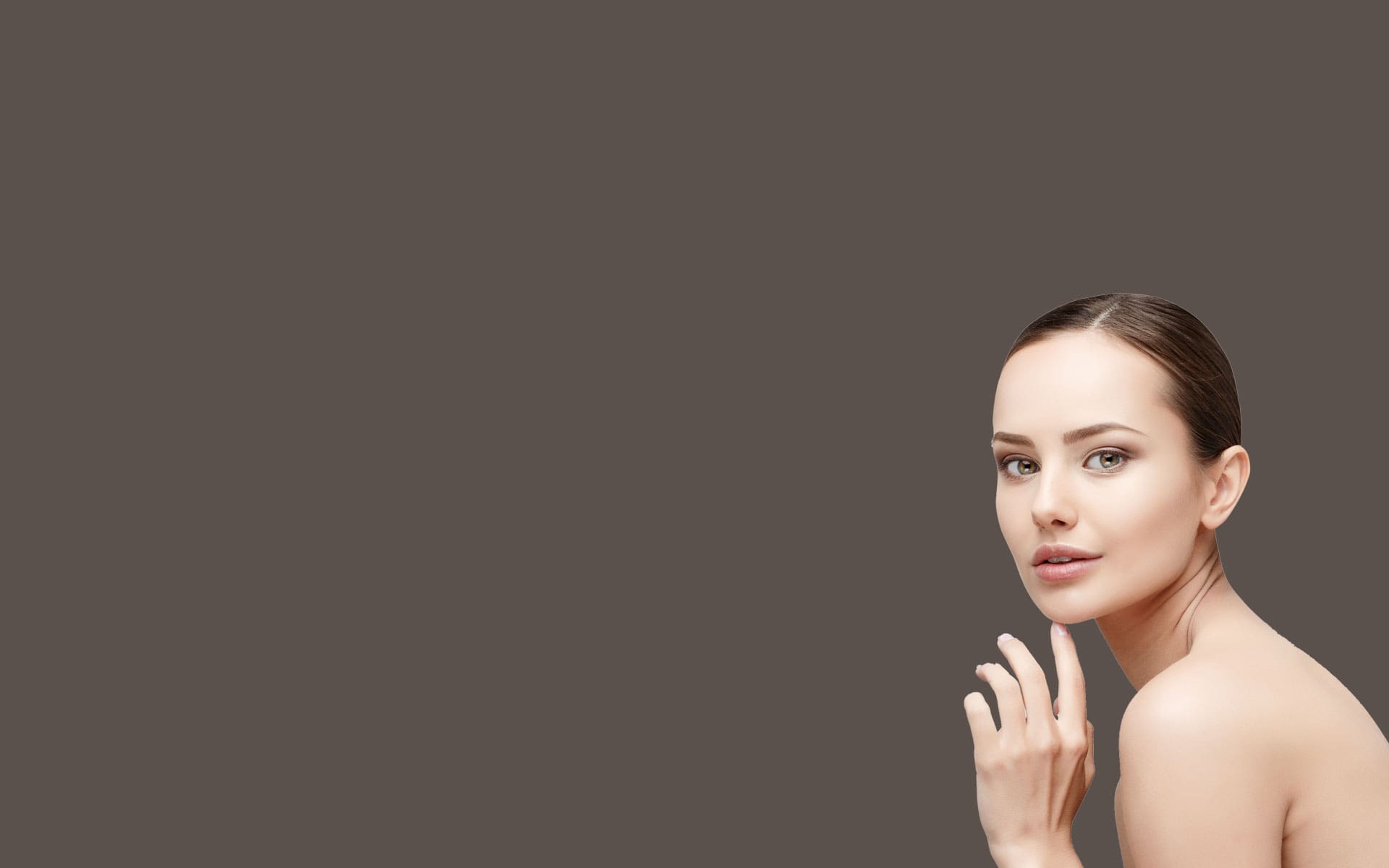 A woman with her hand up to her face.